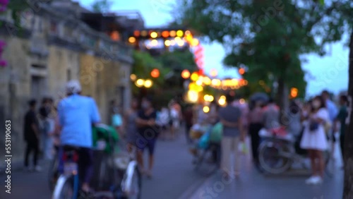 Blurry shot of Hoi An town street full with toursts photo