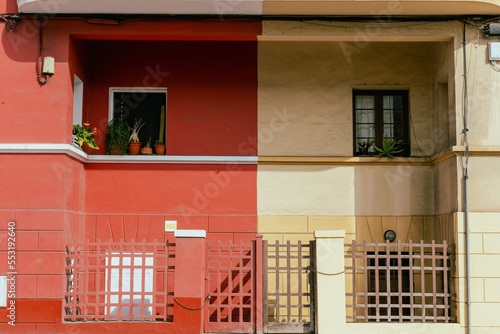 Red and yellow neigbour houses with symmetrical windows at Las Palmas, Spain. photo
