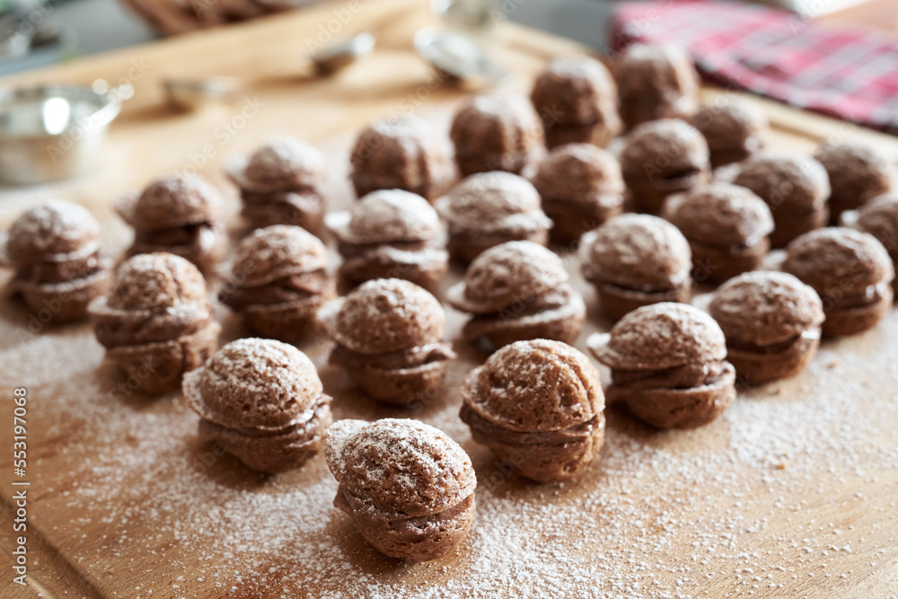 Handmade Christmas chocolate cookies filled with cream and dusted with sugar Handmade Christmas chocolate cookies filled with cream and dusted with sugar