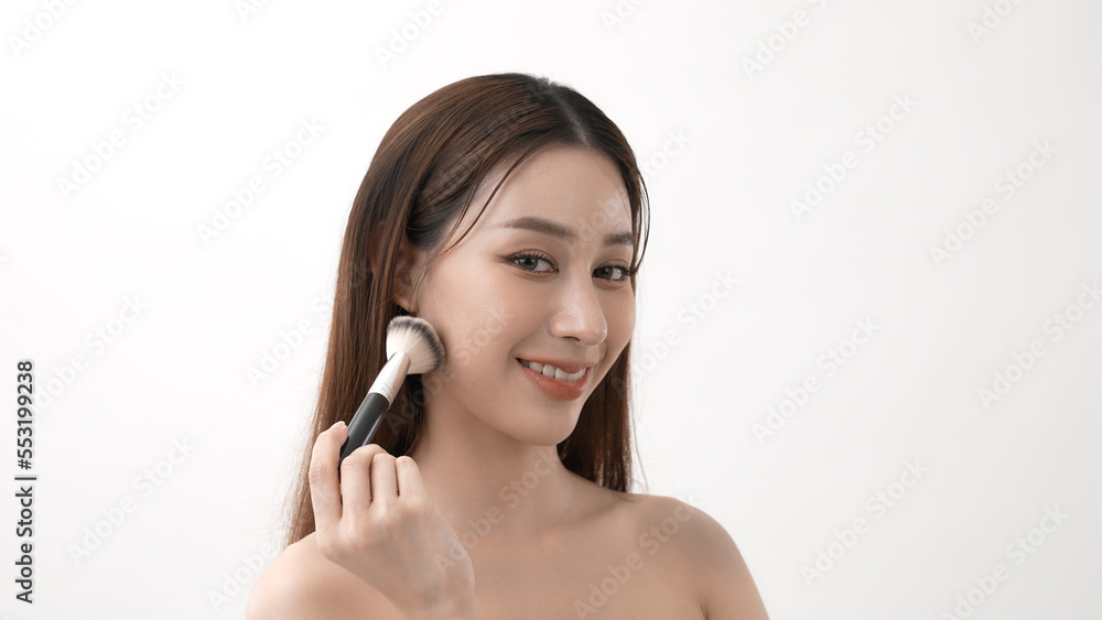 Beauty concept of 4k Resolution. Asian girls brushing their cheeks with a powder foundation. Beauty concept of 4k Resolution. Asian girls brushing their cheeks with a powder foundation.