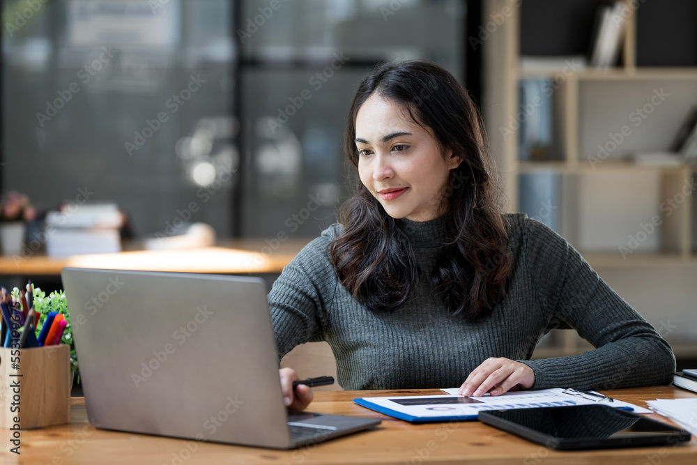 Portrait of Young asian indian Businesswoman Sitting at Her Desk Working on Laptop Computer. Portrait of Young asian indian Businesswoman Sitting at Her Desk Working on Laptop Computer.