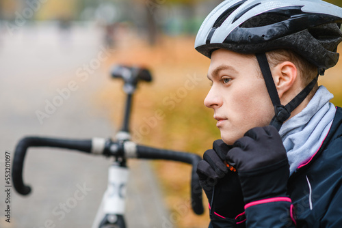Profile of young bicyclist wear helmet outdoors