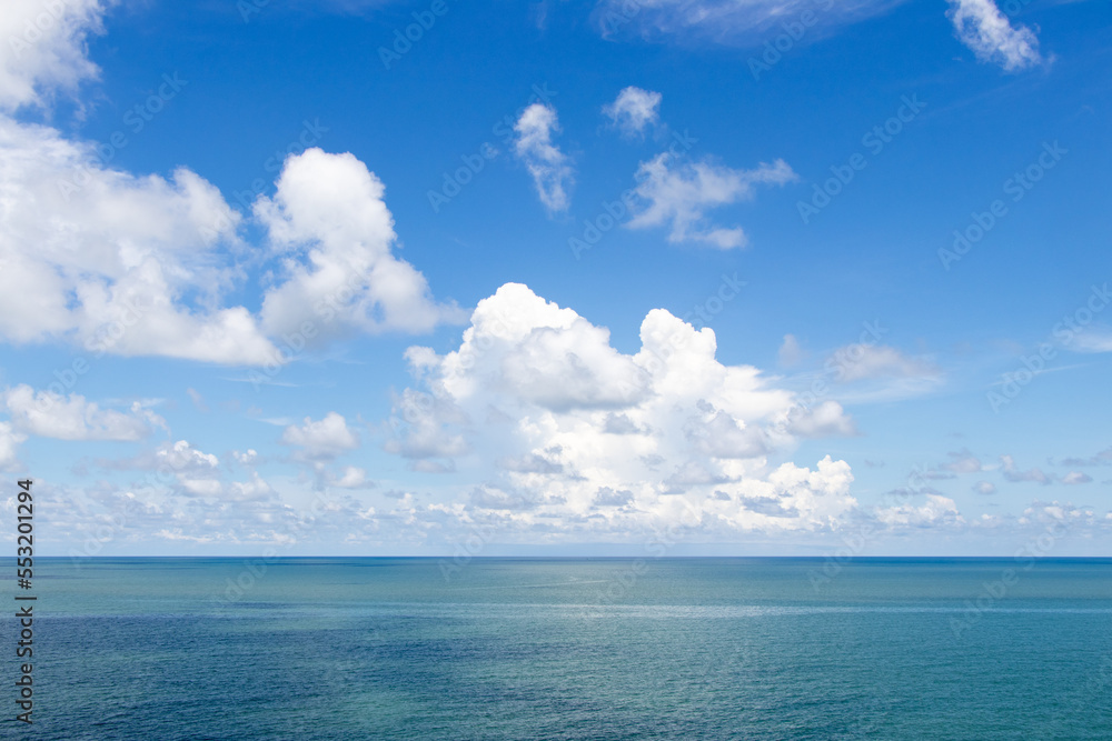 Beautiful calm turquoise color sea and blue sky with white color cloud background