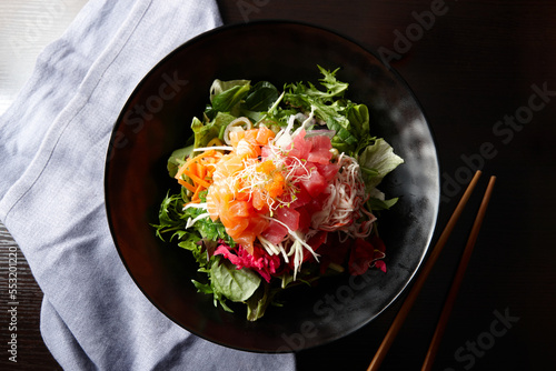 Sashimi salad on black plate