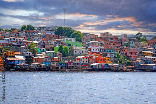 Picture of a housing estate in manaus with colorful houses taken from the Amazon River photo
