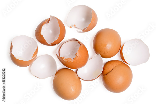 Top view broken eggshells stacked on white background.