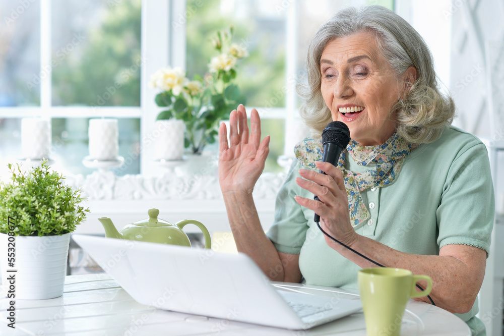 Portrait of beautiful senior woman singing karaoke Portrait of beautiful senior woman singing karaoke