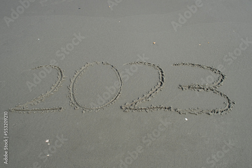 2023 written in sand on the beach