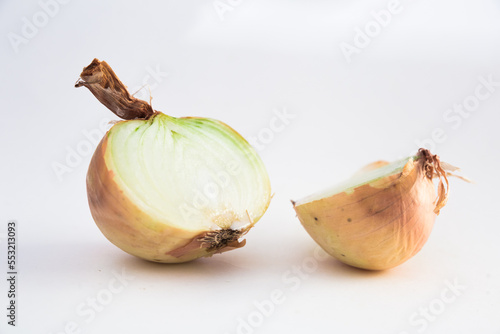 halves of ripe onions on black stone board