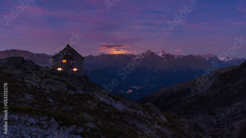 Full moonrising above alpine ridge behind the hut
