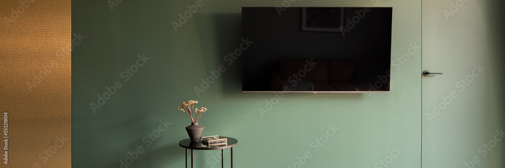 Unique design in tv room with green and gold wall, panorama Stock Photo ...