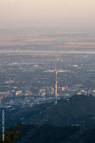 TV tower on the background of the city. a city at the foot of the mountains