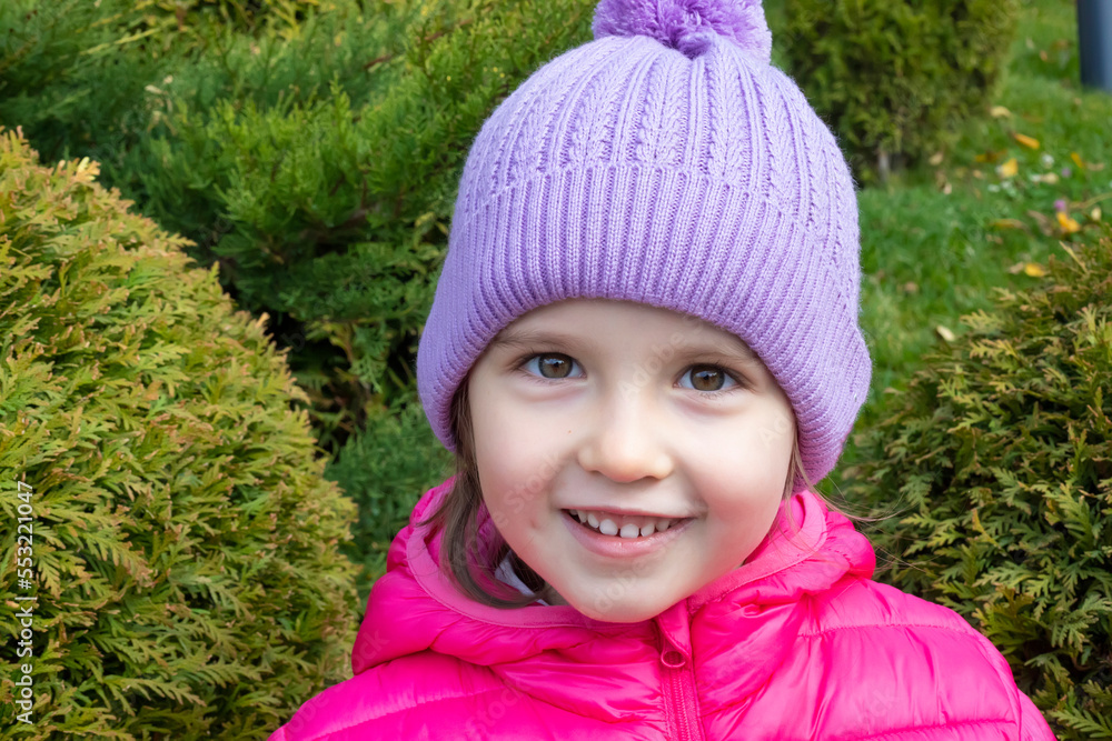 Portrait of cute happy girl in warm clothes on autumn day Portrait of cute happy girl in warm clothes on autumn day