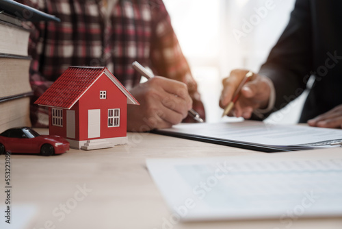 Sign a contract, Credit approver, businessman in male suit and house toy model mockup Home loan mortgage approval concept. After signing the contract