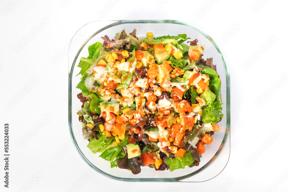 Salmon salad with green leaves and avocado in glass bowl isolated on white background. Salmon salad with green leaves and avocado in glass bowl isolated on white background.