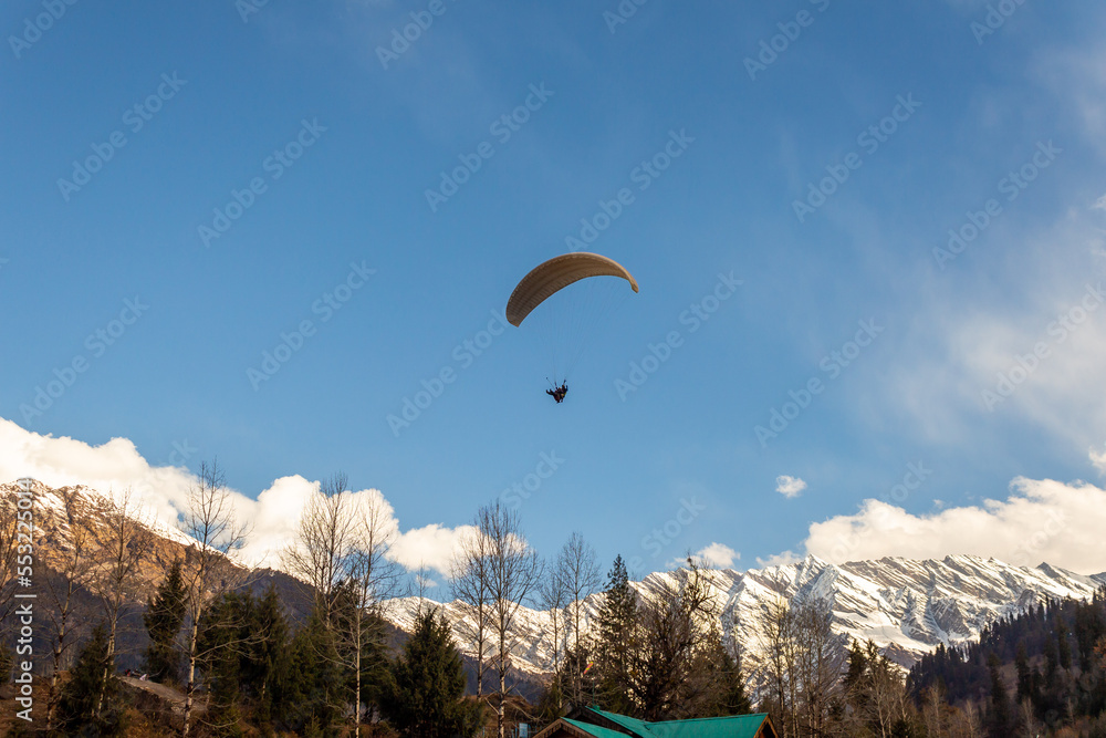Manali Paragliding in the blue sky with snow mountains of Manali in Himachal Pradesh. Panoramic views of Himalayas. Natural beauty of Solang Valley. Manali Himachal Pradesh. Rohtang Pass Snow winters. Manali Paragliding in the blue sky with snow mountains of Manali in Himachal Pradesh. Panoramic views of Himalayas. Natural beauty of Solang Valley. Manali Himachal Pradesh. Rohtang Pass Snow winters.