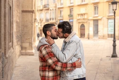 young gay couple in love hugging and kissing in the street © Renata Hamuda