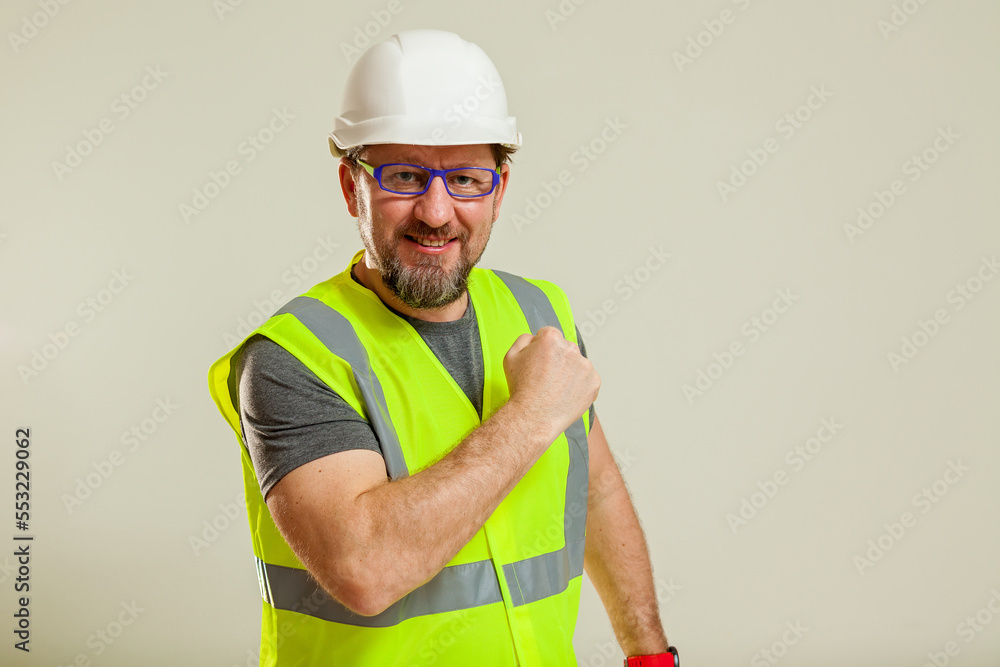 worker in a vest and white helmet worker in a vest and white helmet