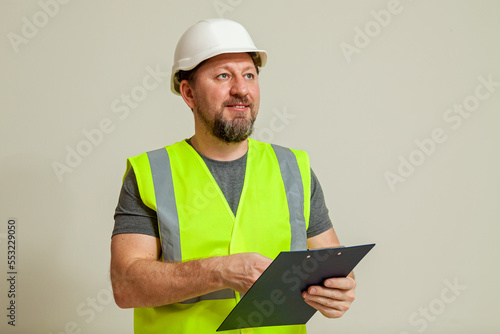 worker in a vest and white helmet