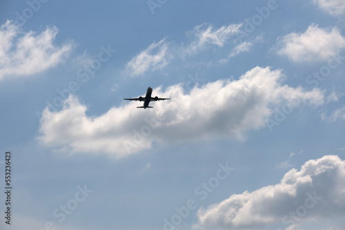 Airplane flying over blue sky and clouds
