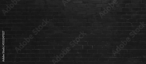Abstract black brick wall pattern background and black backdrop, Blank copy space. Black wall background The surface of the brick dark jagged. Abstract black wall background