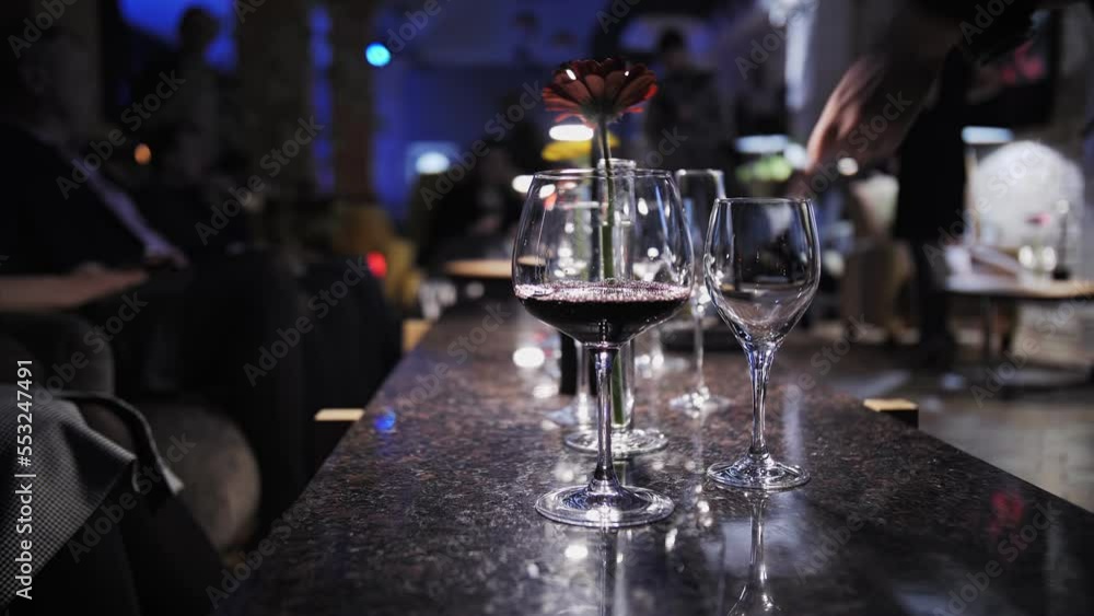 girl pours red wine into glasses girl pours red wine into glasses