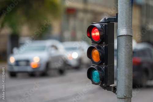 traffic light on the street junction with beautiful bokeh, city with cars in the background