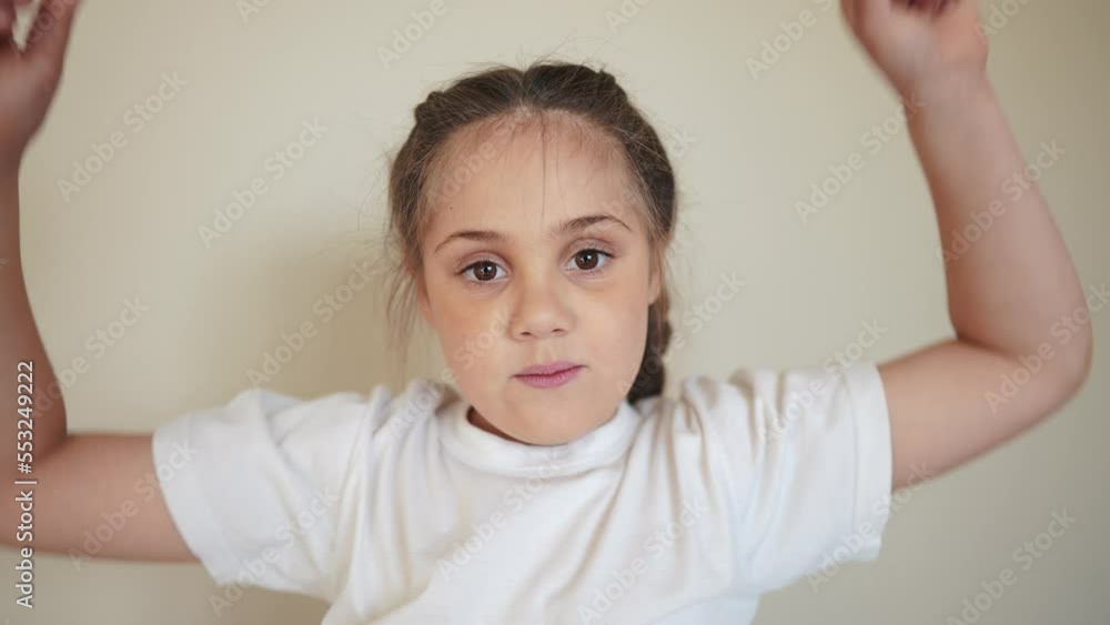 portrait child girl looking at the camera. happy family kid dream concept. baby indoors eyes down then look at the camera and smiles. funny portrait girl kid close-up. smile teeth fell out portrait child girl looking at the camera. happy family kid dream concept. baby indoors eyes down then look at the camera and smiles. funny portrait girl kid close-up. smile teeth fell out