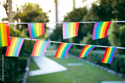 Closeup of gay PRIDE with heart shaped rainbow flag on wrist. Rainbow tattoo. LGBTQ pride month symbol. Equal rights.