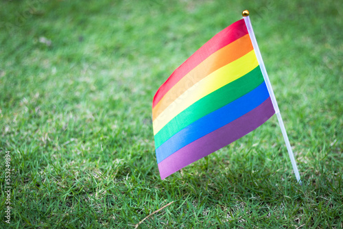Closeup of gay PRIDE with heart shaped rainbow flag on wrist. Rainbow tattoo. LGBTQ pride month symbol. Equal rights.