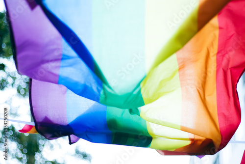 Closeup of gay PRIDE with heart shaped rainbow flag on wrist. Rainbow tattoo. LGBTQ pride month symbol. Equal rights.