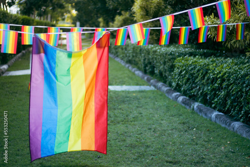 Closeup of gay PRIDE with heart shaped rainbow flag on wrist. Rainbow tattoo. LGBTQ pride month symbol. Equal rights.