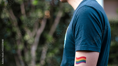 Closeup of gay PRIDE with heart shaped rainbow flag on wrist. Rainbow tattoo. LGBTQ pride month symbol. Equal rights.