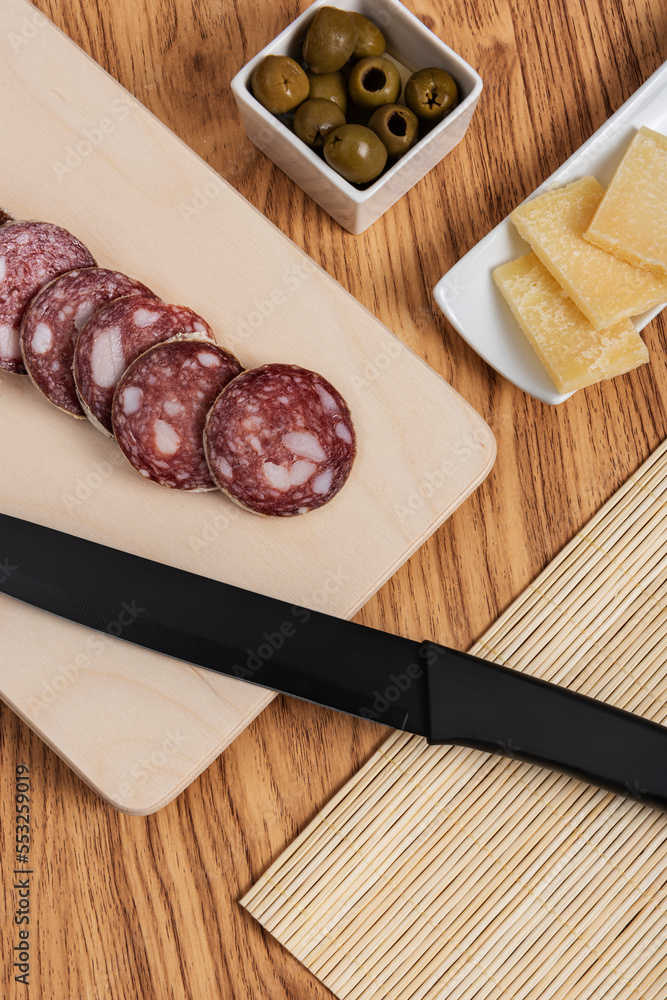 appetizer platter with salami and cheese with black knife appetizer platter with salami and cheese with black knife