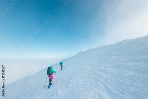 two girls climb the mountain.