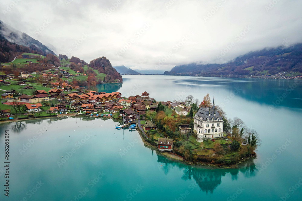 Aerial view, Iseltwald village with idyllic nature scenery of lake Brienz with turquoise waters. Switzerland