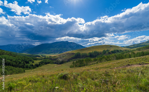 Green mountain hillside with summer clouds building © Charles Baden