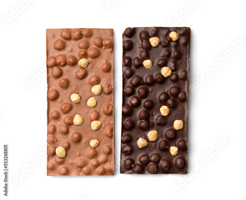 Milk and dark chocolate with nuts on a white background top view.