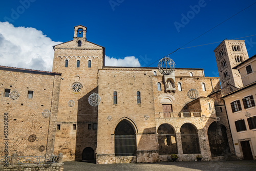 Side facade of the Cathedral Basilica of Santa Maria Annunziata, in Piazza Innocenzo III. Stone buildings from the Middle Ages. Niche with a statue of Pope Boniface VIII. Anagni, Frosinone, Italy. photo