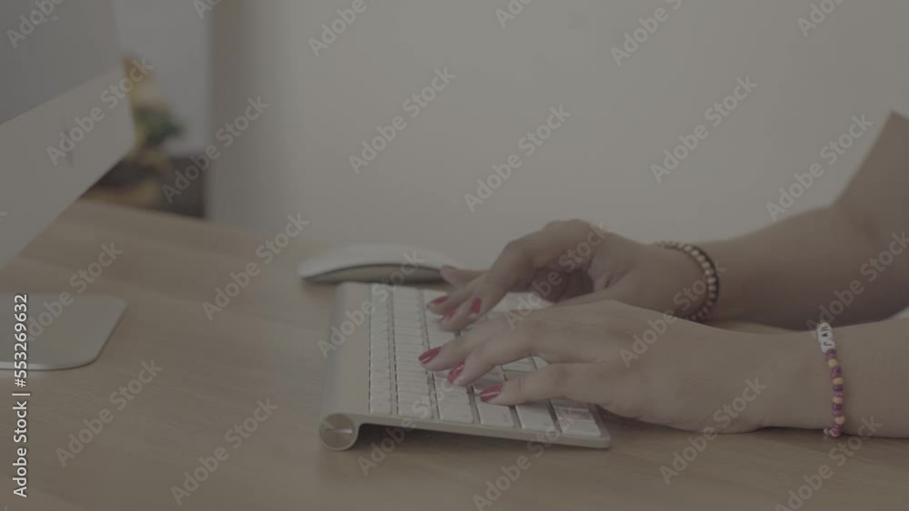 Manos de mujer tecleando en una computadora blanca 