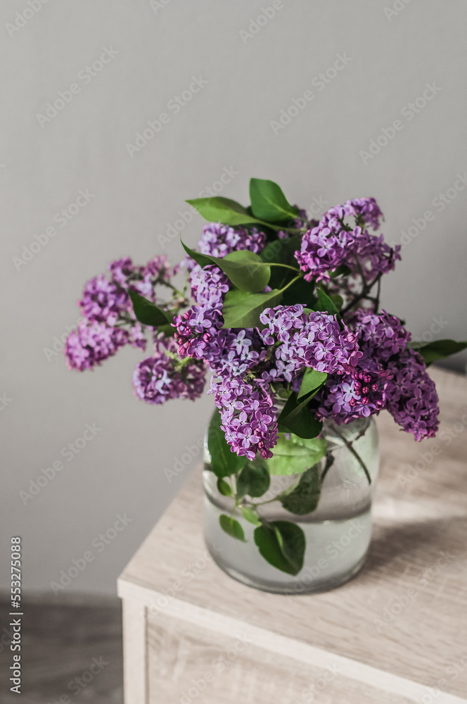 A bouquet of fresh lilacs in a glass vase top view. A bouquet of fresh lilacs in a glass vase top view.