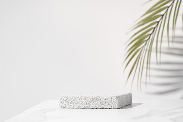 Porous pedestal on white table for beauty cosmetic product presentation. Bathroom shelf mockup.