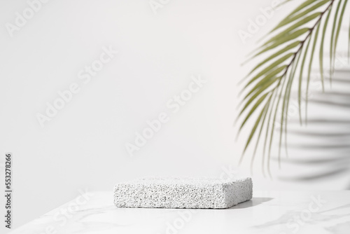 Porous pedestal on white table for beauty cosmetic product presentation. Bathroom shelf mockup.