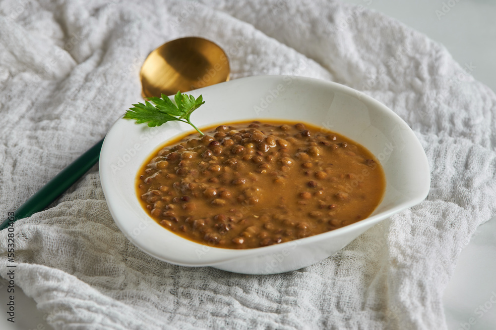 Bowl of lentil soup near spoon Bowl of lentil soup near spoon