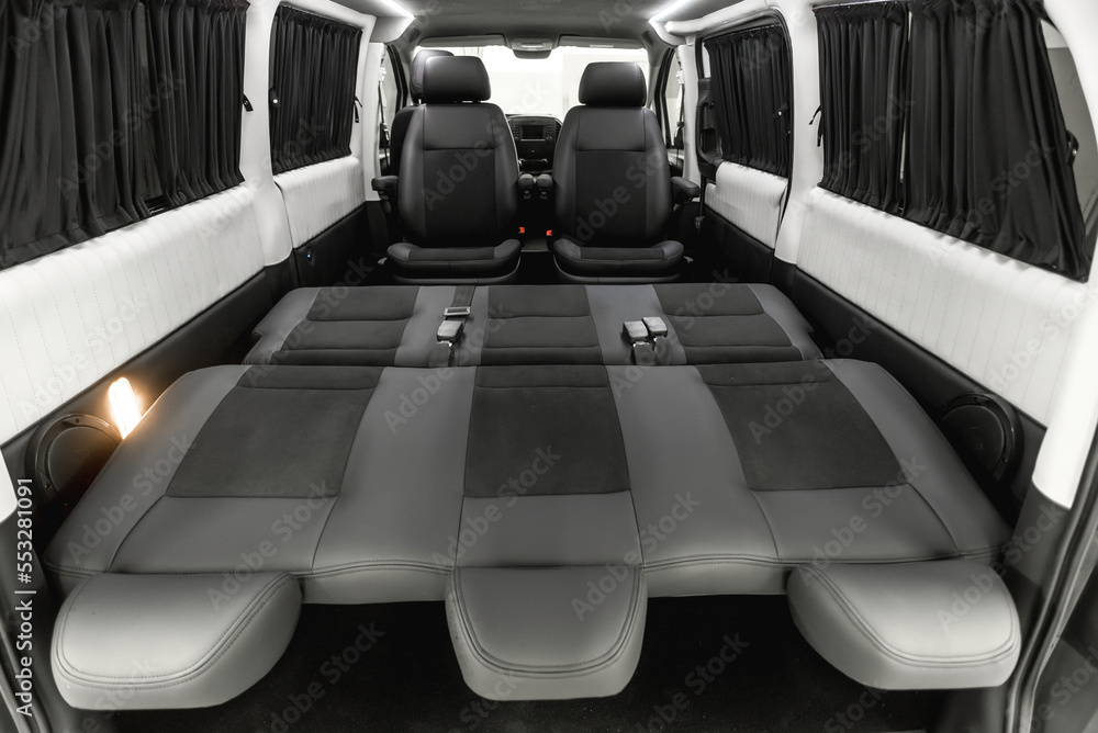 Fototapeta premium comfortable passenger bus interior with upholstered seats; individual transfer for a group of people; conversion of the interior of a truck;