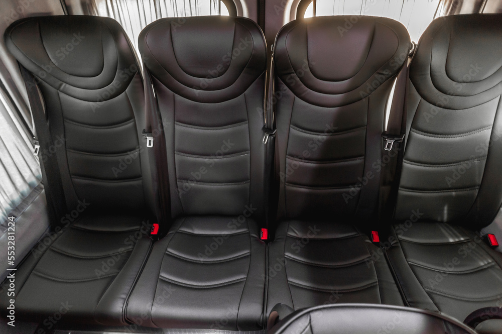 Obraz premium comfortable passenger bus interior with upholstered seats; individual transfer for a group of people; conversion of the interior of a truck; 