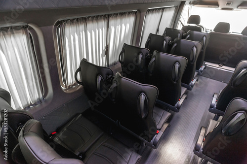 comfortable passenger bus interior with upholstered seats; individual transfer for a group of people; conversion of the interior of a truck; 