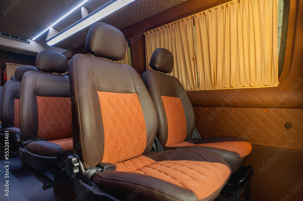 Obraz premium comfortable passenger bus interior with upholstered seats; individual transfer for a group of people; conversion of the interior of a truck; 