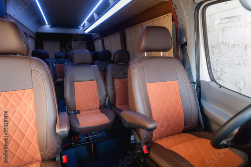 comfortable passenger bus interior with upholstered seats  individual transfer for a group of people  conversion of the interior of a truck   © Kaminski Vadim