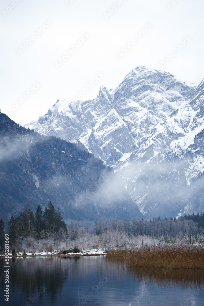 Mountain Lake and Snowy Mountain Range on a Misty Winter Day in Austria